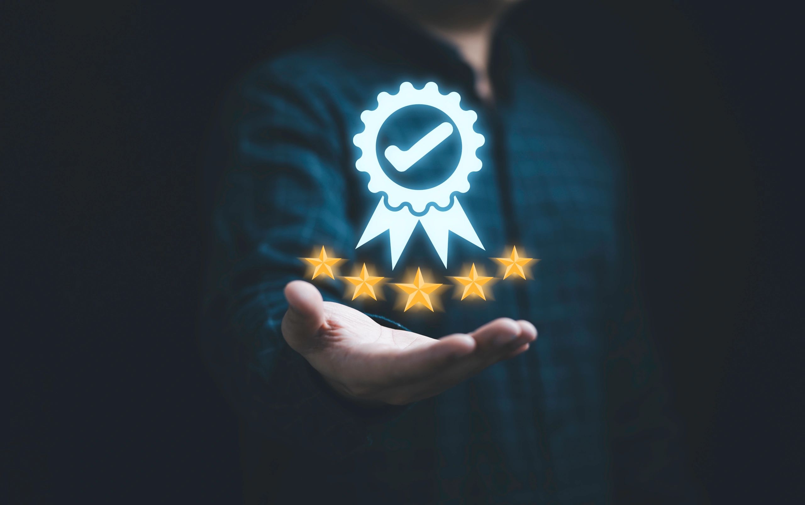 Businessman holding and showing the best quality assurance